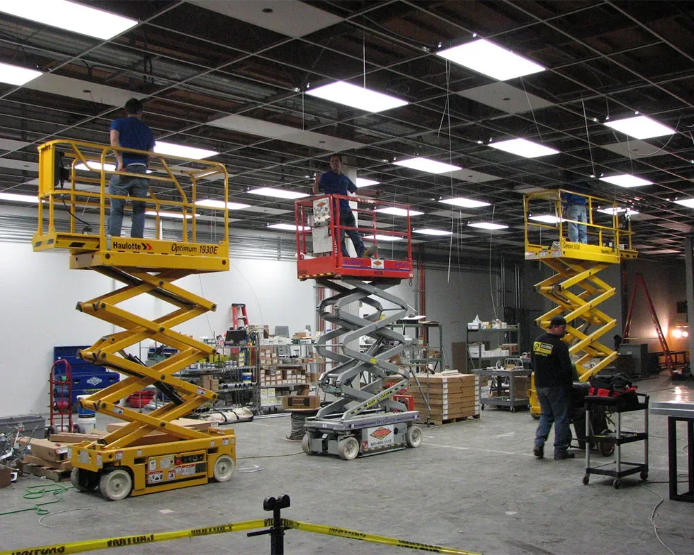 Commercial electrical work with lifts and crew overhead